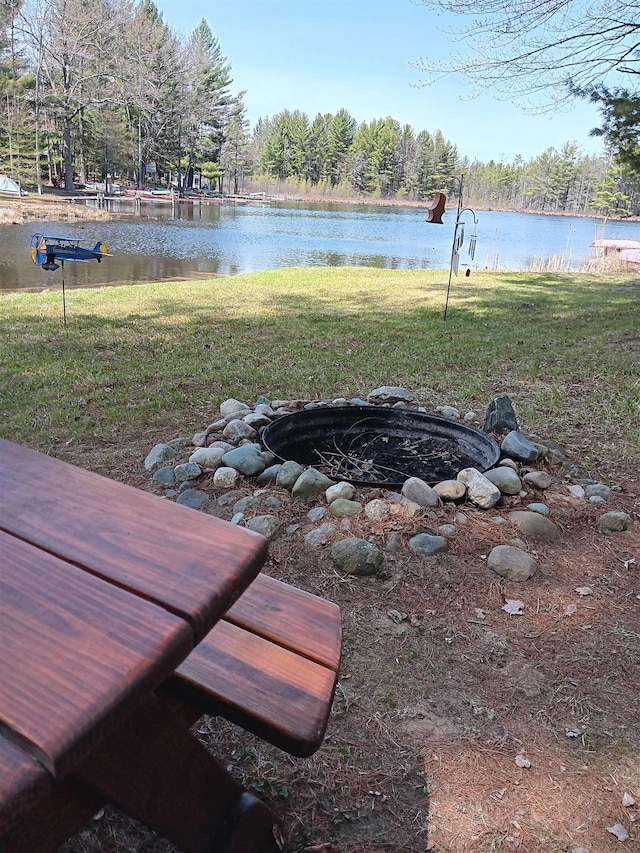 view of yard featuring a water view and an outdoor fire pit