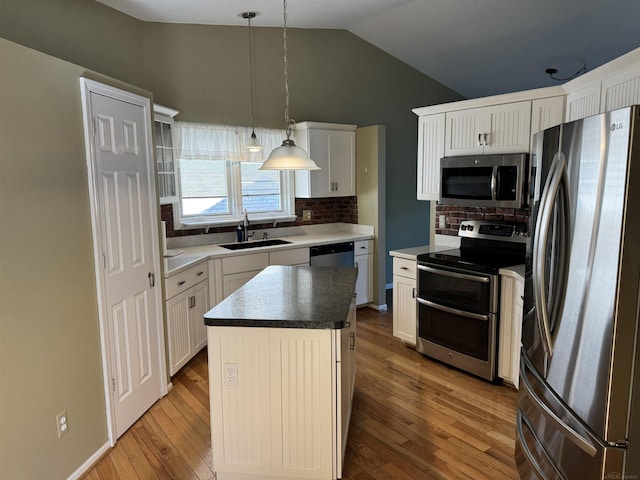 kitchen featuring a sink, decorative backsplash, light wood-style flooring, and stainless steel appliances