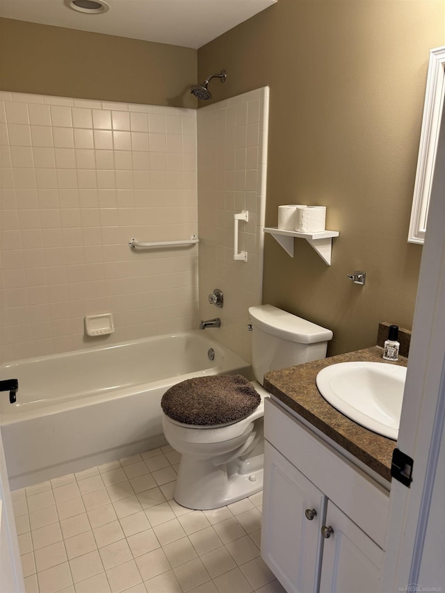 bathroom featuring tile patterned floors, vanity, toilet, and shower / washtub combination