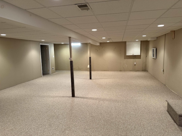 finished basement with visible vents, carpet flooring, recessed lighting, and a paneled ceiling