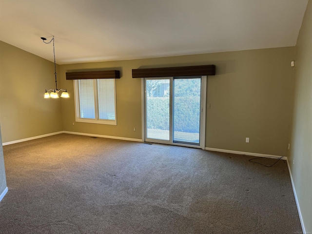 unfurnished room featuring carpet floors and baseboards