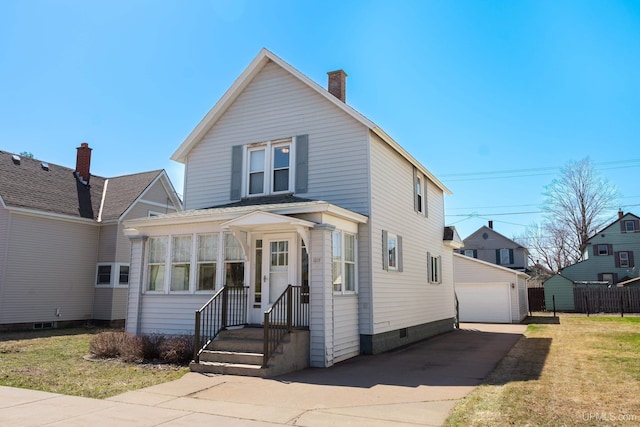 view of front of house with an outdoor structure, a front lawn, a chimney, and a detached garage