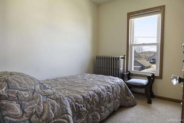 bedroom featuring baseboards, radiator heating unit, and carpet