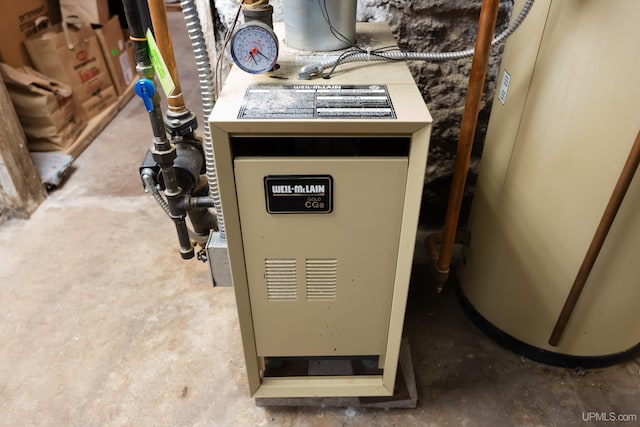 utility room featuring water heater and a heating unit