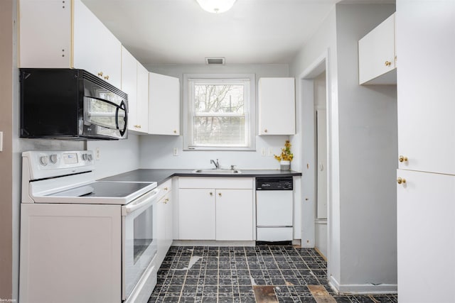 kitchen featuring white cabinets, dark countertops, a sink, white appliances, and visible vents