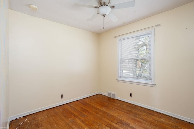 unfurnished room with baseboards, ceiling fan, wood-type flooring, and visible vents