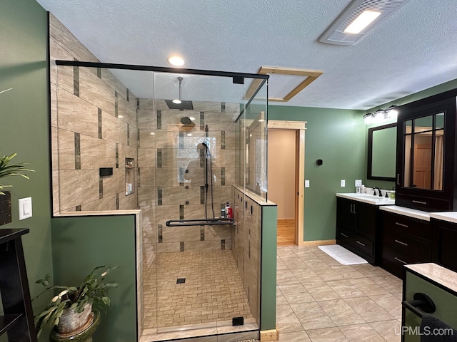 full bath featuring vanity, baseboards, a stall shower, and visible vents