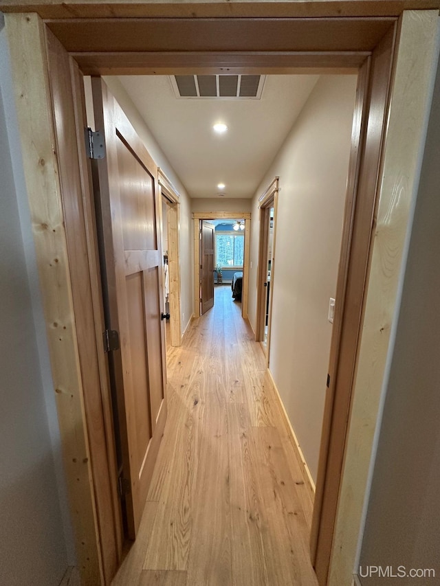 hall with visible vents, recessed lighting, baseboards, and light wood-type flooring