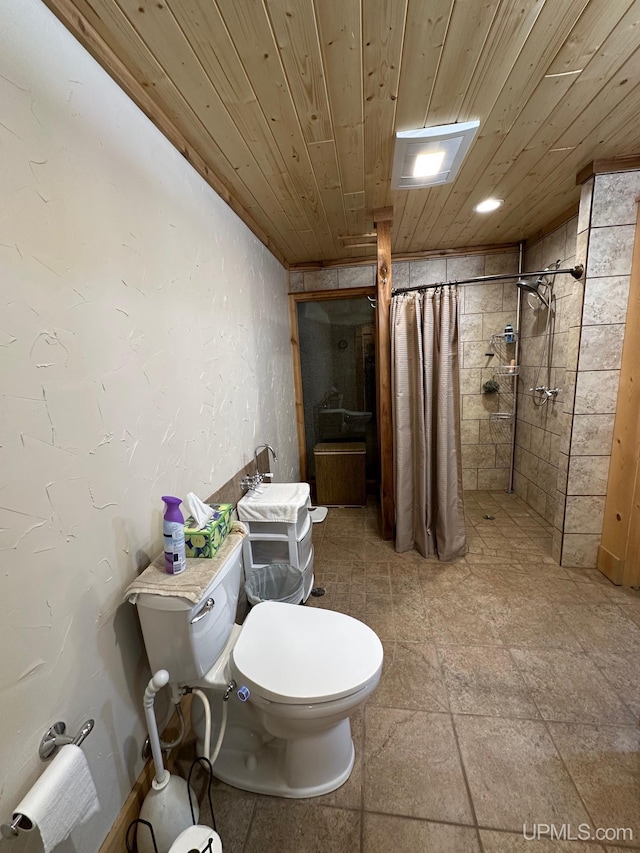 bathroom featuring a tile shower, wooden ceiling, and toilet