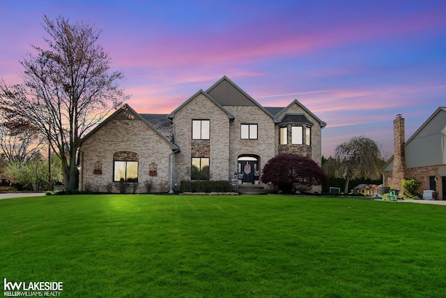 french country style house featuring a lawn