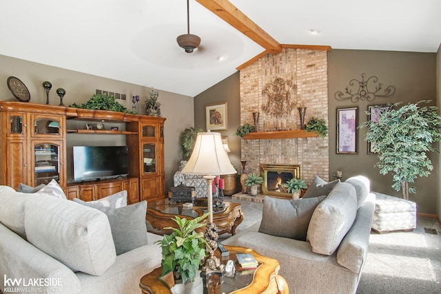 living room featuring lofted ceiling with beams, carpet, and a fireplace