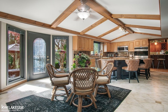 dining room with visible vents, lofted ceiling with beams, a ceiling fan, and light tile patterned floors