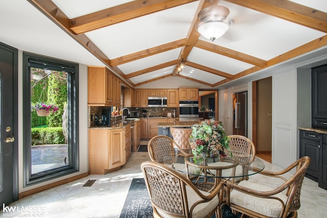 dining area with vaulted ceiling with beams, a ceiling fan, and visible vents