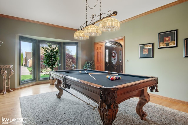 recreation room featuring pool table, ornamental molding, baseboards, and wood finished floors