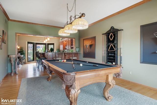 game room featuring pool table, visible vents, ornamental molding, and light wood-style flooring