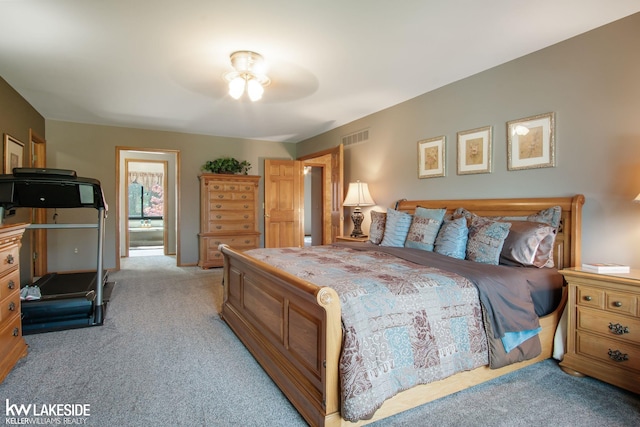 bedroom featuring visible vents and light carpet