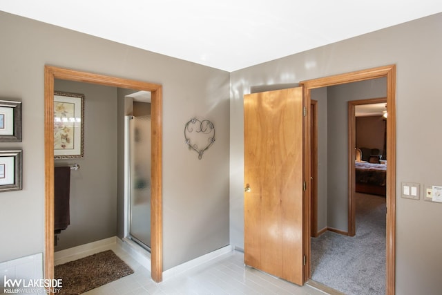 full bath featuring baseboards and a stall shower