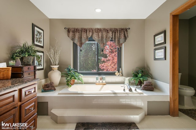 full bath with toilet, tile patterned floors, recessed lighting, and a garden tub