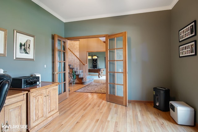 unfurnished office with french doors, ornamental molding, light wood-style floors, and baseboards