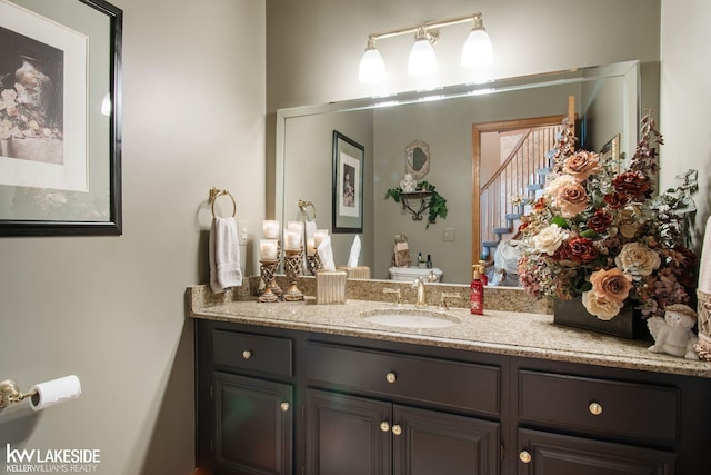 bathroom featuring toilet and vanity