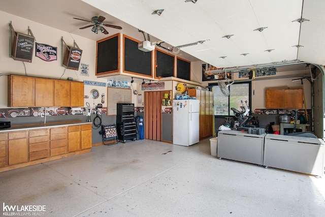 garage with freestanding refrigerator and a ceiling fan
