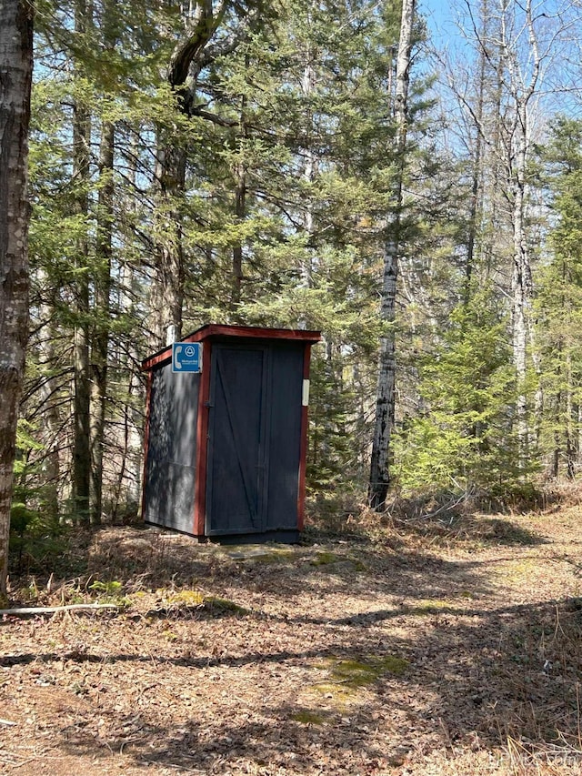 view of shed with a view of trees