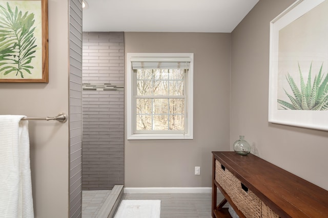 bathroom featuring baseboards and a tile shower