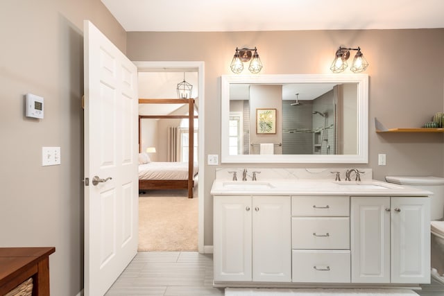 bathroom featuring double vanity, a sink, a walk in shower, and connected bathroom