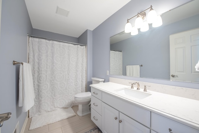 full bath with toilet, visible vents, wood finished floors, and vanity