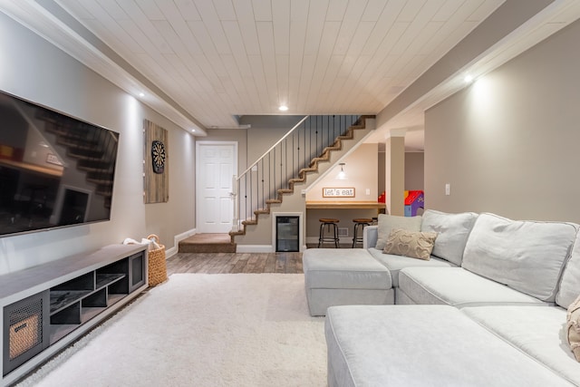 living area with recessed lighting, baseboards, stairs, and wood finished floors