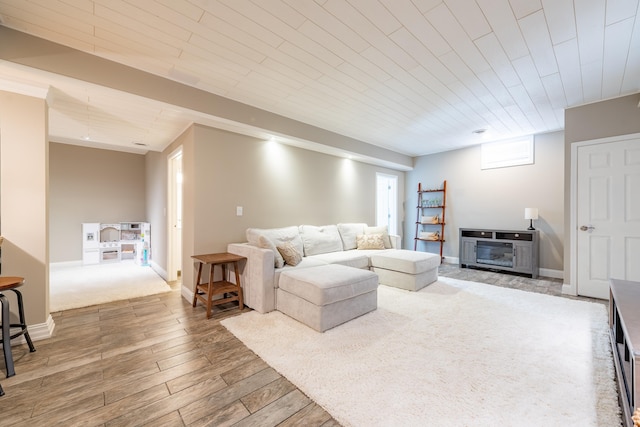 living room with baseboards, wood finished floors, and wooden ceiling