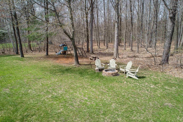 view of yard with a playground and an outdoor fire pit