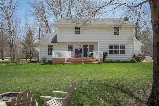 back of property with central AC unit, crawl space, a yard, and a deck