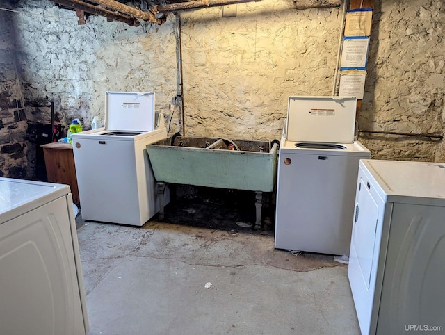 laundry area featuring washer and dryer, laundry area, and a sink