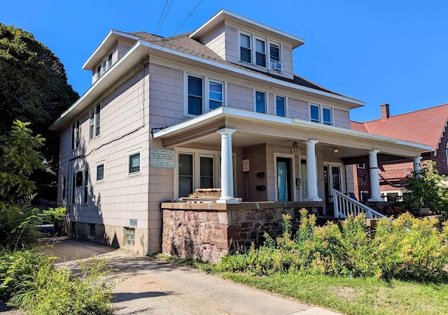 traditional style home featuring covered porch