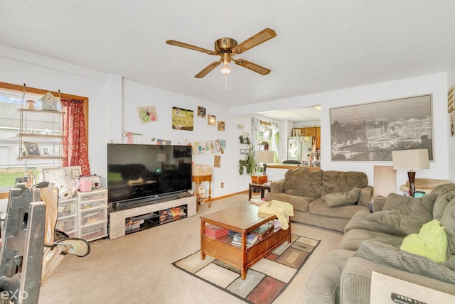 carpeted living room featuring ceiling fan
