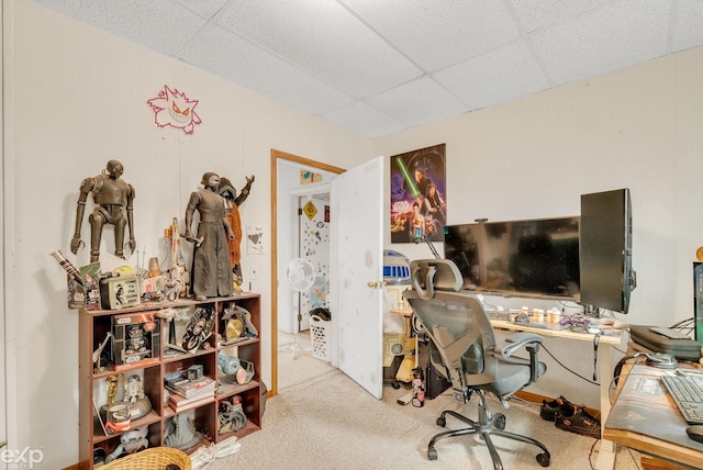 carpeted office space featuring a paneled ceiling