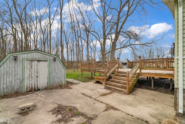 view of patio / terrace featuring an outbuilding, a storage shed, and a deck