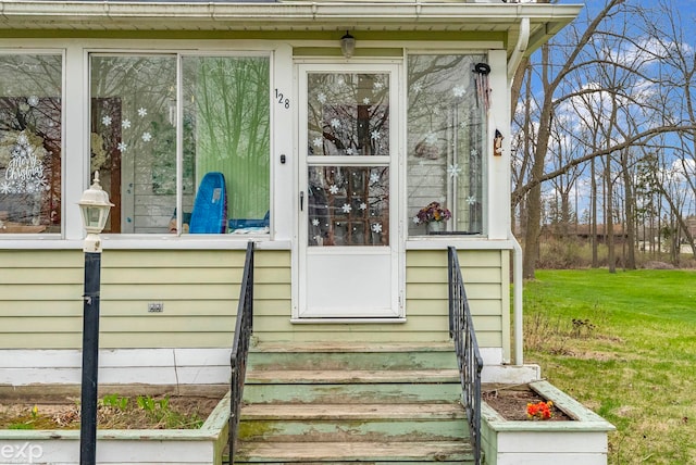 doorway to property with a yard