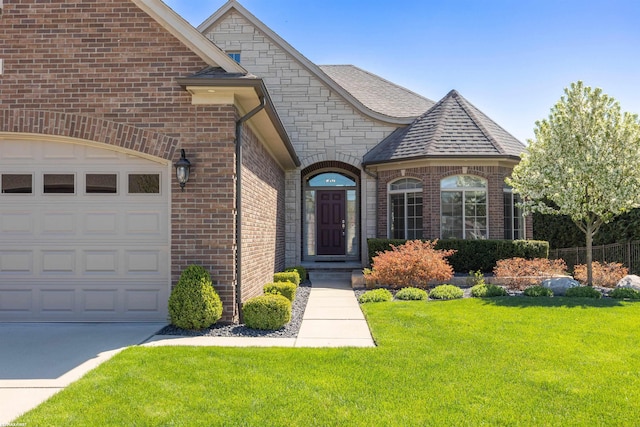 view of front of property with brick siding, a garage, roof with shingles, and a front lawn