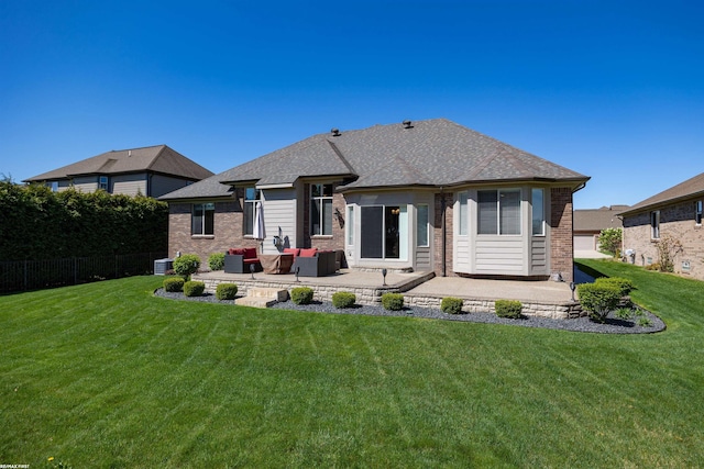 back of house featuring a yard, brick siding, fence, and a patio
