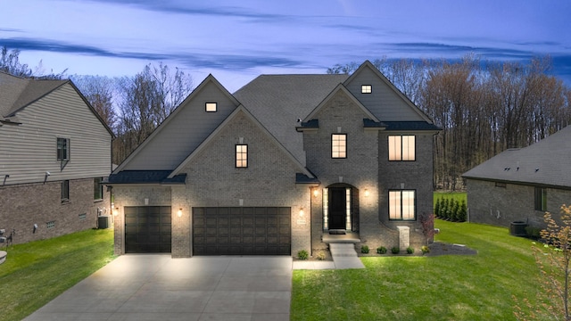 traditional-style house with concrete driveway, brick siding, cooling unit, and a front lawn