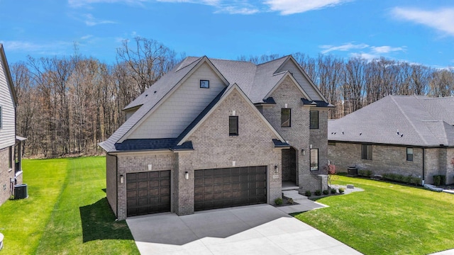 view of front of home with concrete driveway, brick siding, an attached garage, and a front yard