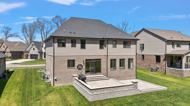 rear view of house with a residential view, a yard, central AC, and brick siding