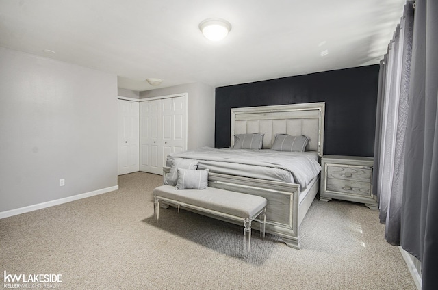 bedroom with a closet, carpet flooring, and baseboards