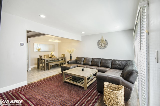 living room featuring baseboards, recessed lighting, and wood finished floors