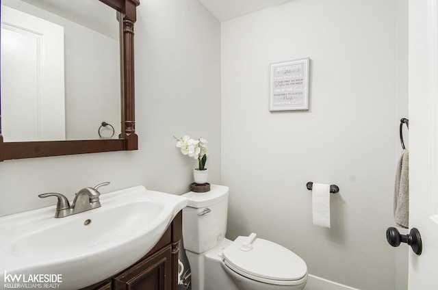 half bath with vanity and toilet