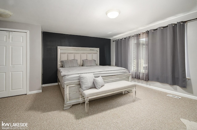 bedroom with visible vents, carpet, and baseboards