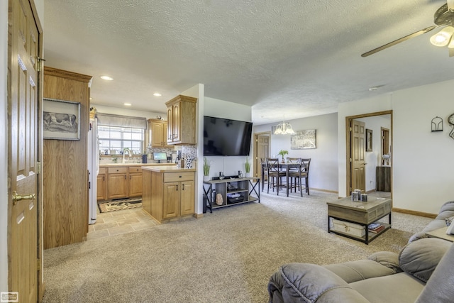 8765 Winn Rd, Brown City, MI 48416 - living area with ceiling fan with notable chandelier, recessed lighting, a textured ceiling, and light colored carpet