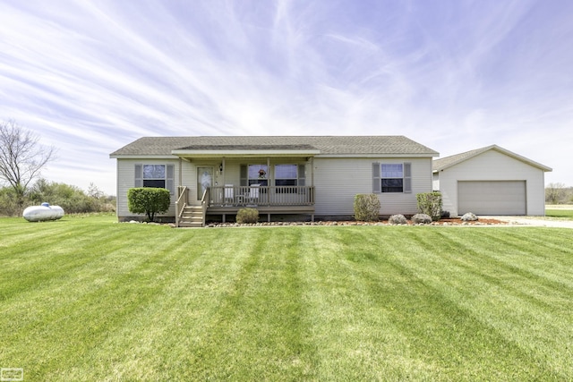 8765 Winn Rd, Brown City, MI 48416 - ranch-style house featuring covered porch, an attached garage, an outdoor structure, and a front yard